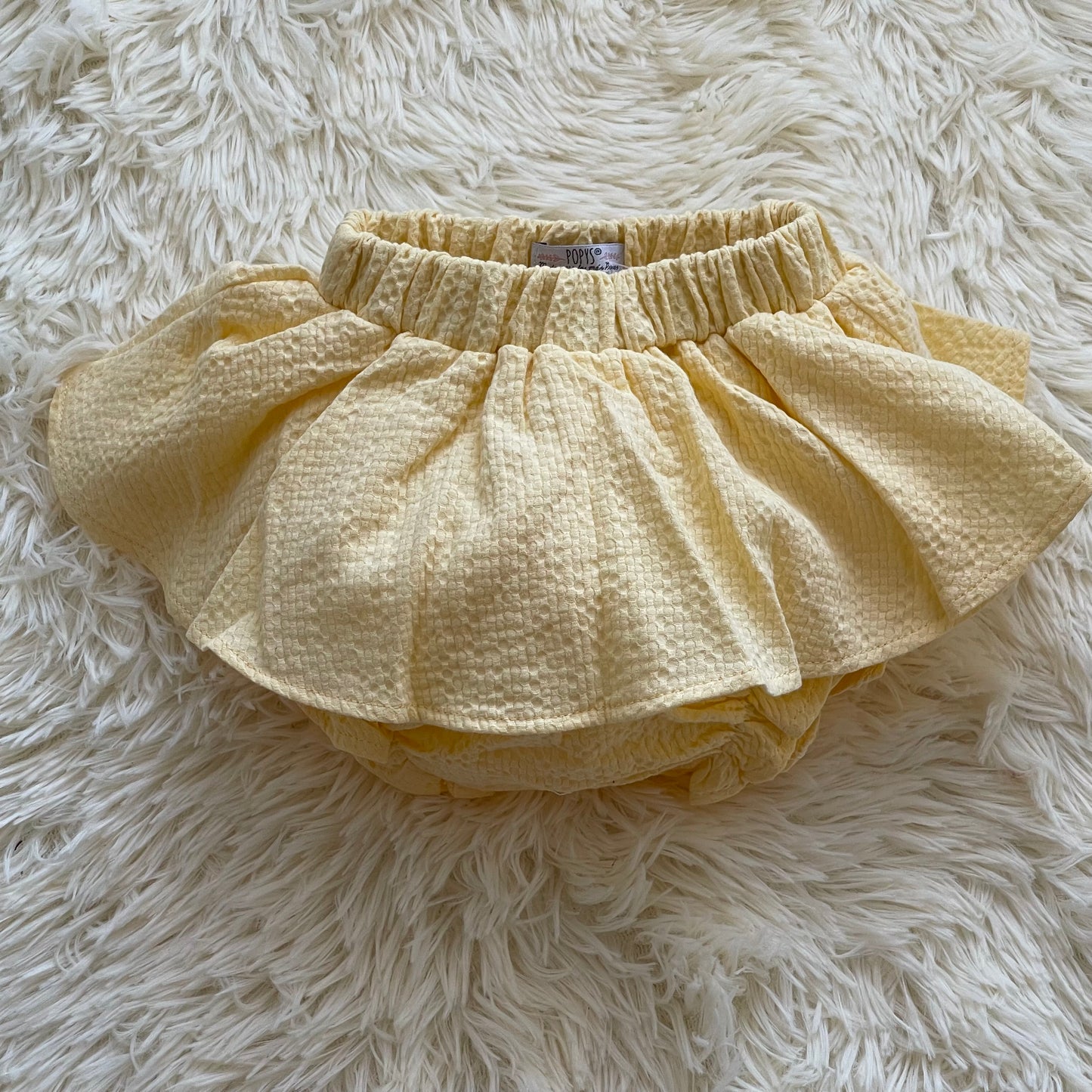 Comprar faldas cubrepañal para bebé niña. Color amarillo. Marca Confecciones Popys.